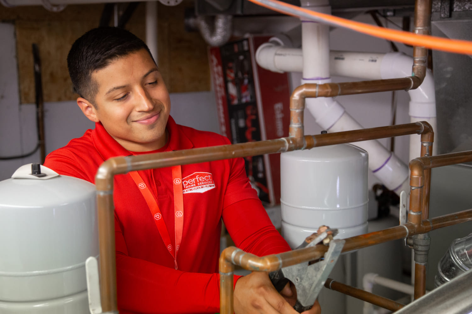 Perfect Home Services technician repairing plumbing pipes