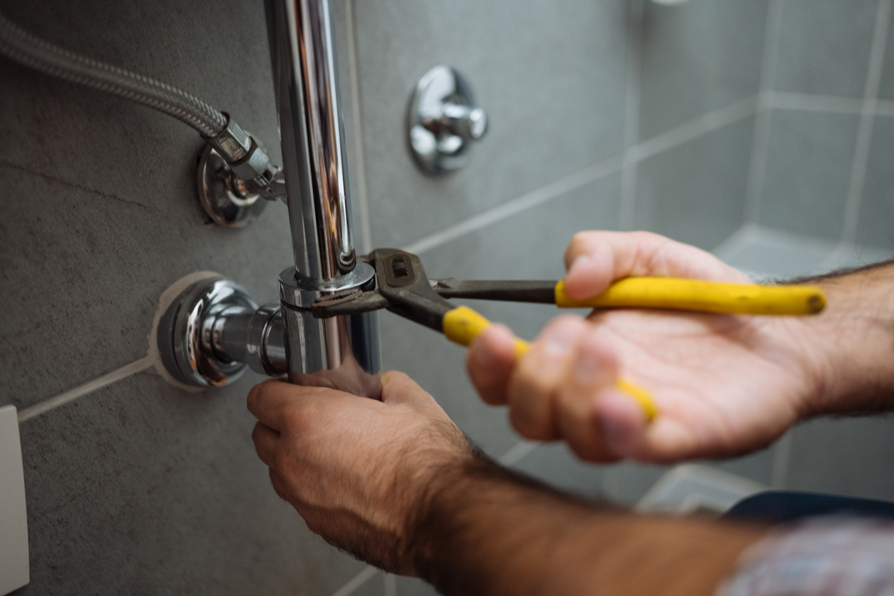 Plumber Fixing Faucet
